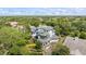 Stunning aerial view of a luxury home featuring mature landscaping and a private setting at 1058 Roundstone Pl, Palm Harbor, FL 34683