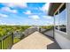 Spacious balcony with views of neighborhood and blue skies at 1058 Roundstone Pl, Palm Harbor, FL 34683