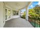 Large covered balcony offering views of tropical landscaping, featuring ceiling fan and ample space for entertaining at 1058 Roundstone Pl, Palm Harbor, FL 34683