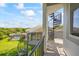 Balcony featuring a spiral staircase with views of the backyard, pool, and surrounding greenery at 1058 Roundstone Pl, Palm Harbor, FL 34683