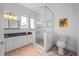 Modern bathroom with glass enclosed shower, decorative tile, vanity, and toilet at 1058 Roundstone Pl, Palm Harbor, FL 34683