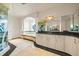 Luxurious bathroom featuring a soaking tub with columns, decorative shower, and granite countertop vanity at 1058 Roundstone Pl, Palm Harbor, FL 34683