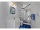Charming bathroom with marine decorations, featuring a glass-enclosed shower and white sink at 1058 Roundstone Pl, Palm Harbor, FL 34683