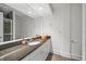 Bathroom features a modern vanity with gray countertop and a large mirror at 1058 Roundstone Pl, Palm Harbor, FL 34683