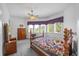 Comfortable bedroom featuring a ceiling fan, large windows and vintage furniture, providing natural light and a cozy atmosphere at 1058 Roundstone Pl, Palm Harbor, FL 34683
