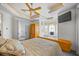 Bedroom featuring tray ceiling, TV, and window seat below bright window at 1058 Roundstone Pl, Palm Harbor, FL 34683