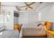 Bedroom with tray ceilings and fan, two closets, and a window seat below a bright window at 1058 Roundstone Pl, Palm Harbor, FL 34683