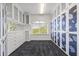 Spacious walk-in closet featuring custom white cabinetry with glass fronts and a large window at 1058 Roundstone Pl, Palm Harbor, FL 34683