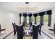Dining room featuring a glass table, six chairs, and a modern sculpture centerpiece at 1058 Roundstone Pl, Palm Harbor, FL 34683