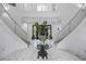 Bright foyer with marble floors, grand staircase, and decorative glass table with floral arrangement at 1058 Roundstone Pl, Palm Harbor, FL 34683