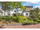 Beautiful home featuring stone accents, manicured landscaping, and a charming brick walkway at 1058 Roundstone Pl, Palm Harbor, FL 34683