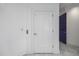 Hallway with marble floors, elevator door, and a modern white door at 1058 Roundstone Pl, Palm Harbor, FL 34683
