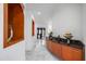 Long hallway featuring wood accents and marble flooring, leading to dining and kitchen areas at 1058 Roundstone Pl, Palm Harbor, FL 34683
