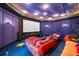 Enjoy movies in this home theater with plush seating, immersive surround sound and large projection screen at 1058 Roundstone Pl, Palm Harbor, FL 34683