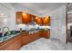 Gourmet kitchen with stainless steel appliances, granite countertops, and custom cabinetry at 1058 Roundstone Pl, Palm Harbor, FL 34683