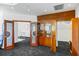 Library featuring custom built-in shelving and glass doors leading to other rooms at 1058 Roundstone Pl, Palm Harbor, FL 34683