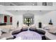Open floorplan with a circular seating arrangement, grand staircase, and decorative accents at 1058 Roundstone Pl, Palm Harbor, FL 34683
