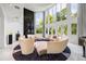 Bright living room with floor-to-ceiling windows, unique circular seating, and dark accent wall at 1058 Roundstone Pl, Palm Harbor, FL 34683