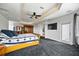 Spacious main bedroom featuring tray ceilings, large closet and dark carpet at 1058 Roundstone Pl, Palm Harbor, FL 34683