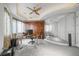 Bright office features custom cabinetry, glass desk and a unique mirrored wall at 1058 Roundstone Pl, Palm Harbor, FL 34683