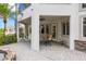 Beautiful outdoor patio with covered seating area, spiral staircase and serene water feature at 1058 Roundstone Pl, Palm Harbor, FL 34683