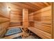 Beautiful wooden sauna with wooden benches and a heater at 1058 Roundstone Pl, Palm Harbor, FL 34683