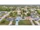 An aerial view of a neighborhood featuring single Gathering homes and mature landscaping with a backyard pool at 12083 Rockford St, Spring Hill, FL 34608