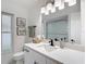 This modern bathroom features a stylish mirror, updated vanity, and appealing wall art at 12083 Rockford St, Spring Hill, FL 34608