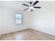 A bright bedroom with hardwood floors, a ceiling fan, and a window to let natural light in at 12083 Rockford St, Spring Hill, FL 34608