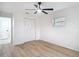 This bedroom features hardwood floors, a ceiling fan, and a closet with white doors at 12083 Rockford St, Spring Hill, FL 34608