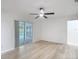 Bedroom with wood-look floors, neutral walls, and access to the pool area through sliding glass doors at 12083 Rockford St, Spring Hill, FL 34608
