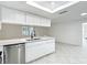 Well-lit eat-in kitchen with quartz countertops, stainless steel dishwasher, and abundant counter space at 12083 Rockford St, Spring Hill, FL 34608