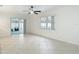 Spacious living room with tile floors features sliding door access to the outdoors at 12083 Rockford St, Spring Hill, FL 34608