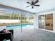 A screened-in pool with a patio and a seating area, adjacent to the home at 12083 Rockford St, Spring Hill, FL 34608