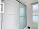 A shower with clear glass door, a handheld shower head, and a window for natural light at 12083 Rockford St, Spring Hill, FL 34608