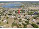 Aerial view of a home near a picturesque lake, showcasing the surrounding community and landscape at 12215 Adventure Dr, Riverview, FL 33579