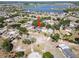 Aerial view of a home with a pool, surrounded by lush trees and neighboring houses, near a lake at 12215 Adventure Dr, Riverview, FL 33579