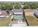 Aerial view of backyard with a screened in pool, a fire pit, and a bocce ball court at 12215 Adventure Dr, Riverview, FL 33579