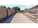 This fenced backyard features a bocce ball court and stone paver patio with seating at 12215 Adventure Dr, Riverview, FL 33579