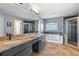 Modern bathroom featuring a jetted tub, double sinks, and a glass-enclosed shower at 12215 Adventure Dr, Riverview, FL 33579