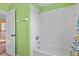 Bathroom with a white tiled shower and tub at 12215 Adventure Dr, Riverview, FL 33579