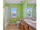 Bright bathroom with a tiled floor, sink and vanity, and shower-tub combo at 12215 Adventure Dr, Riverview, FL 33579