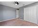 This spacious bedroom features plush carpeting, light grey walls, and a double-door closet at 12215 Adventure Dr, Riverview, FL 33579