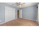 Bedroom with carpeted floors, ceiling fan, and large closet at 12215 Adventure Dr, Riverview, FL 33579