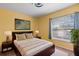 Bedroom features a comfortable bed, nightstands, and a window with natural light at 12215 Adventure Dr, Riverview, FL 33579