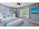 Bedroom with plush bedding, natural lighting, and ocean artwork at 12215 Adventure Dr, Riverview, FL 33579
