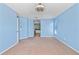 This primary bedroom features blue walls, carpet flooring, and vaulted ceilings at 12215 Adventure Dr, Riverview, FL 33579