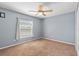 Bedroom with large window and ceiling fan at 12215 Adventure Dr, Riverview, FL 33579