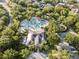 Aerial view of a community pool, playground, clubhouse, and verdant surroundings at 12215 Adventure Dr, Riverview, FL 33579