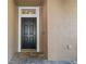Inviting front entryway with a dark wood door and a decorative transom window at 12215 Adventure Dr, Riverview, FL 33579